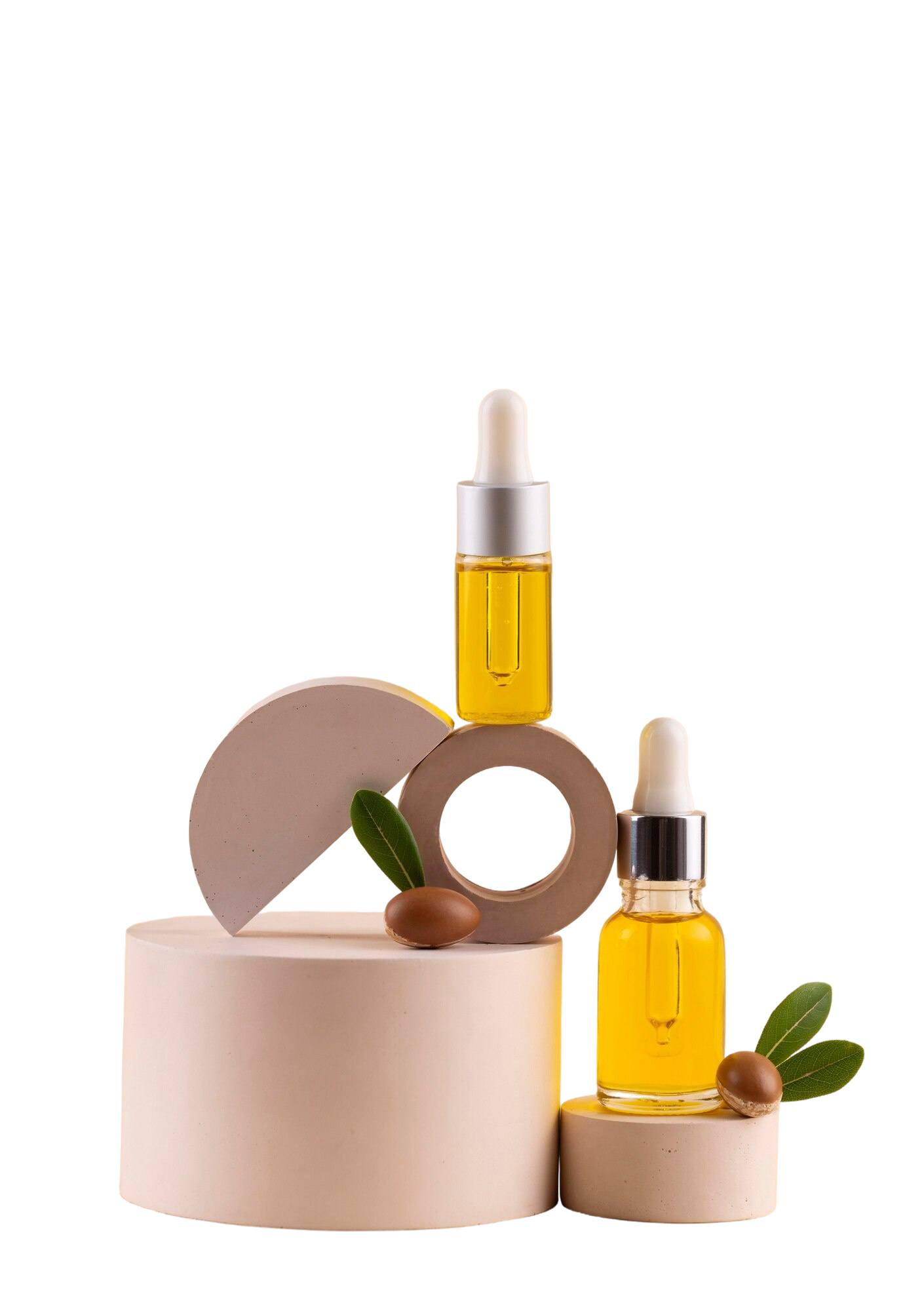 Serum dropper bottles on beige podiums with argan seed and green leaves